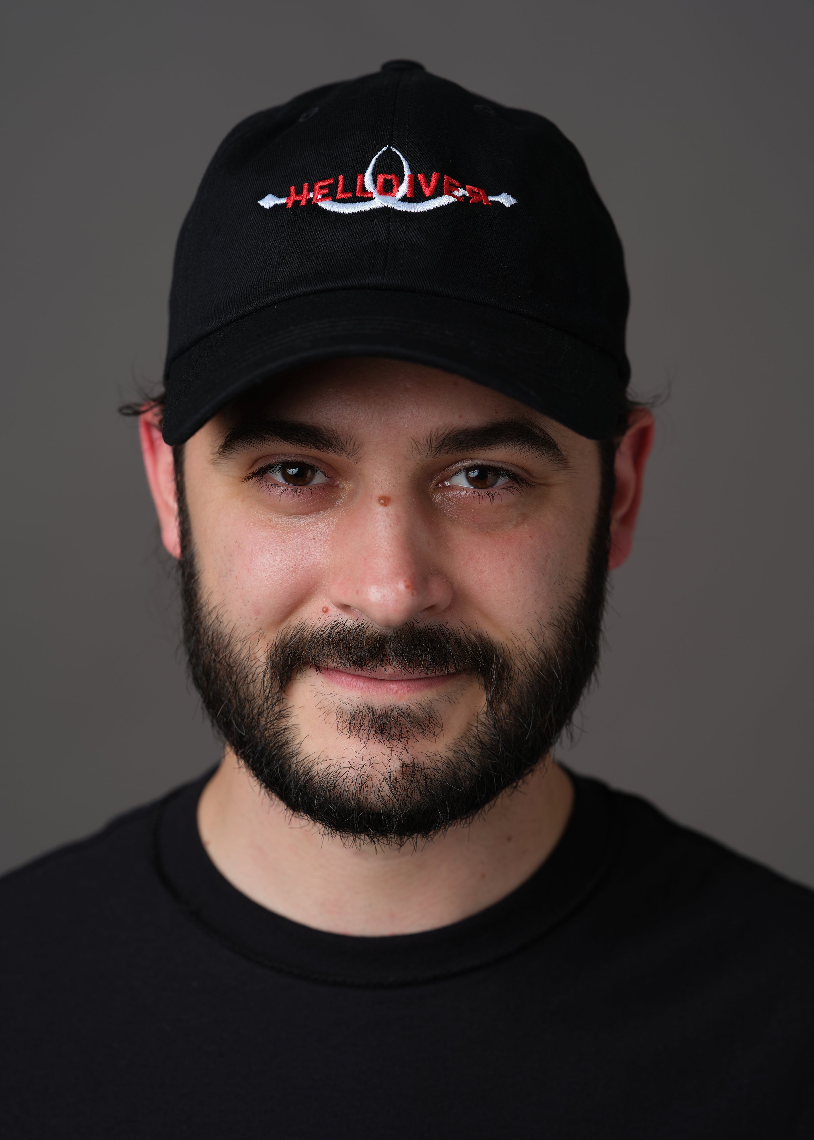 Black hat embroidered with Helldiver in red and two white sling blades
