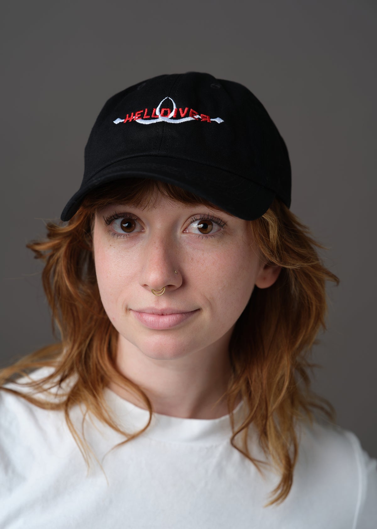 Black hat embroidered with Helldiver in red and two white sling blades
