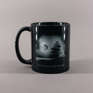 Black mug with a pirate ship on the ocean under a full moon and text that reads 'Stop fucking with the ship' 