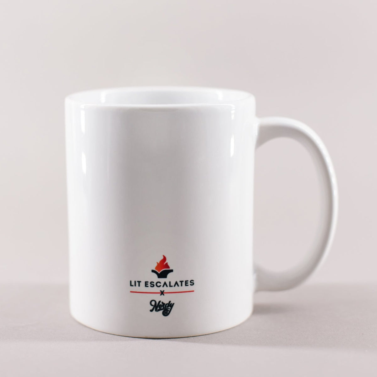 White mug with black and red whiting that says 'Nut to butt sir, don't be shy'
