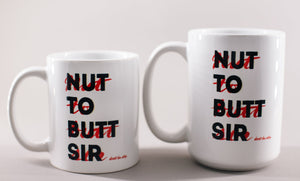 White mug with black and red whiting that says 'Nut to butt sir, don't be shy'