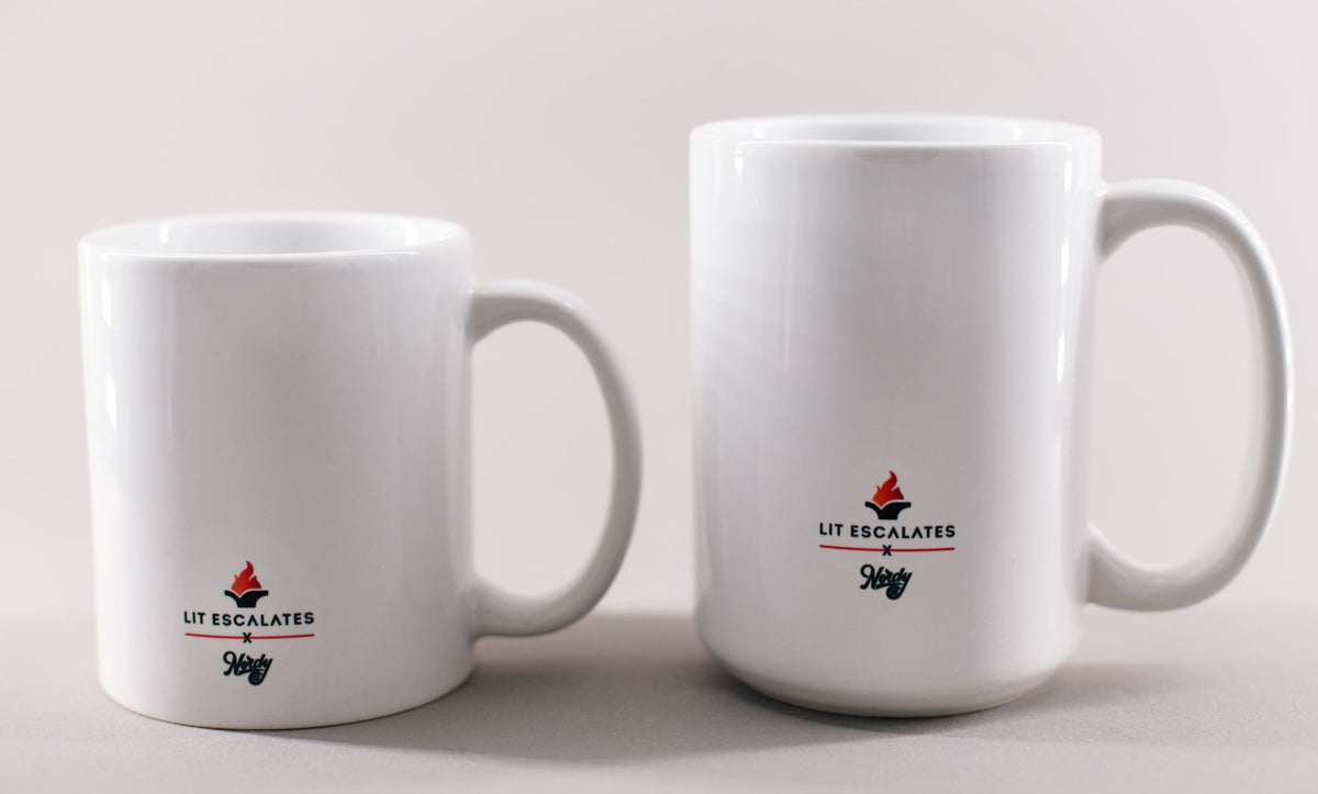 White mug with black and red whiting that says 'Nut to butt sir, don't be shy'