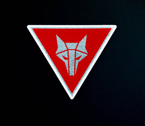 Inverted triangle shaped sticker with red background and a silver Howler sigil in the center