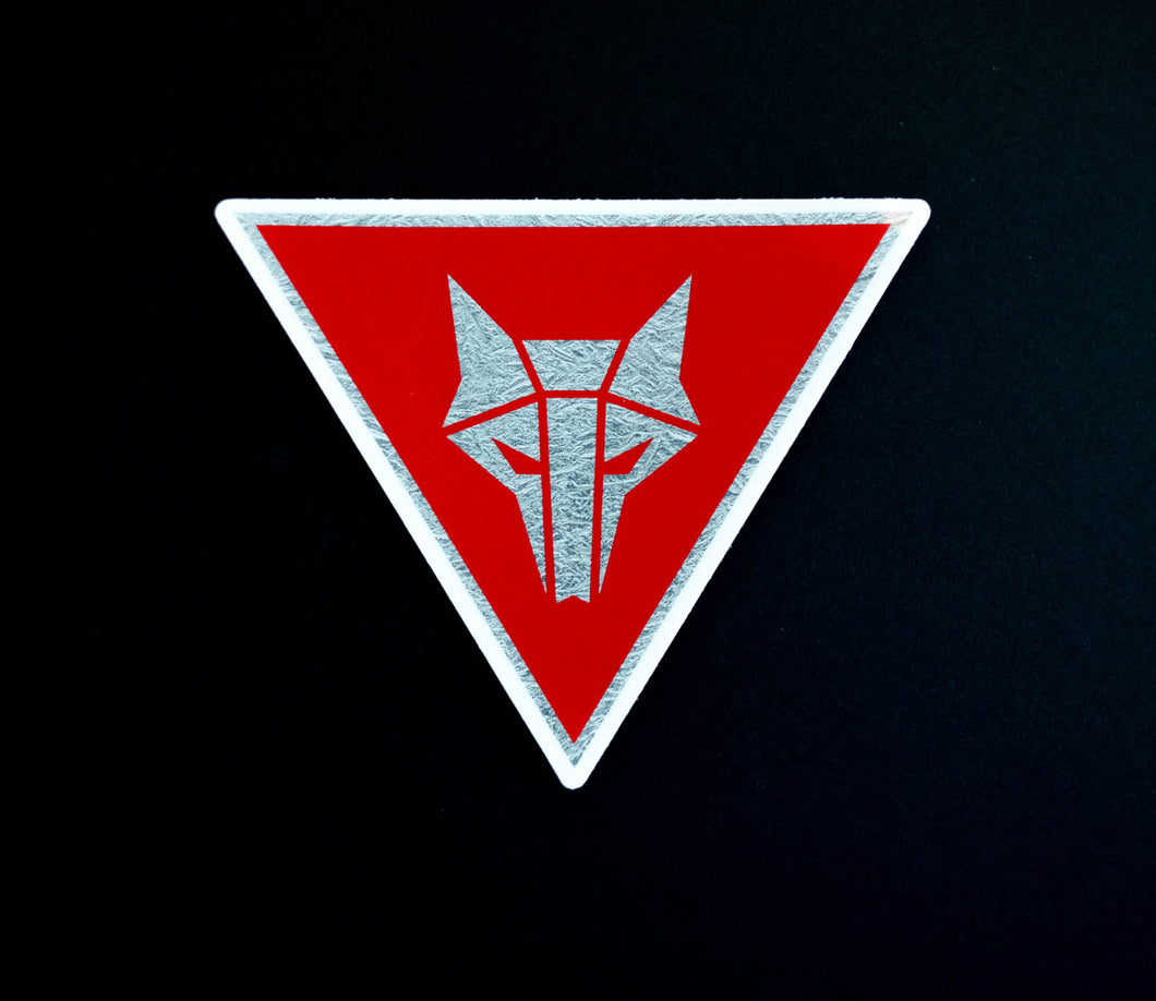 Inverted triangle shaped sticker with red background and a silver Howler sigil in the center