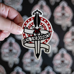 A black and white knife with red initials KL and the phrase 'AS TRAVARS' on a scroll wrapped around, with red circles in the background