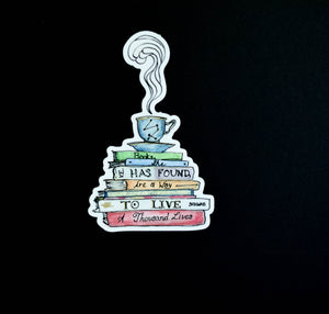 Sticker depicting a steaming tea cup and saucer on top of a stack of books that say "Books, she has found, are a way to live a thousand lives."