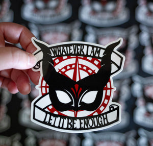 Sticker with a black horned mask and the phrase 'whatever I am let it be enough' on top of a red compass