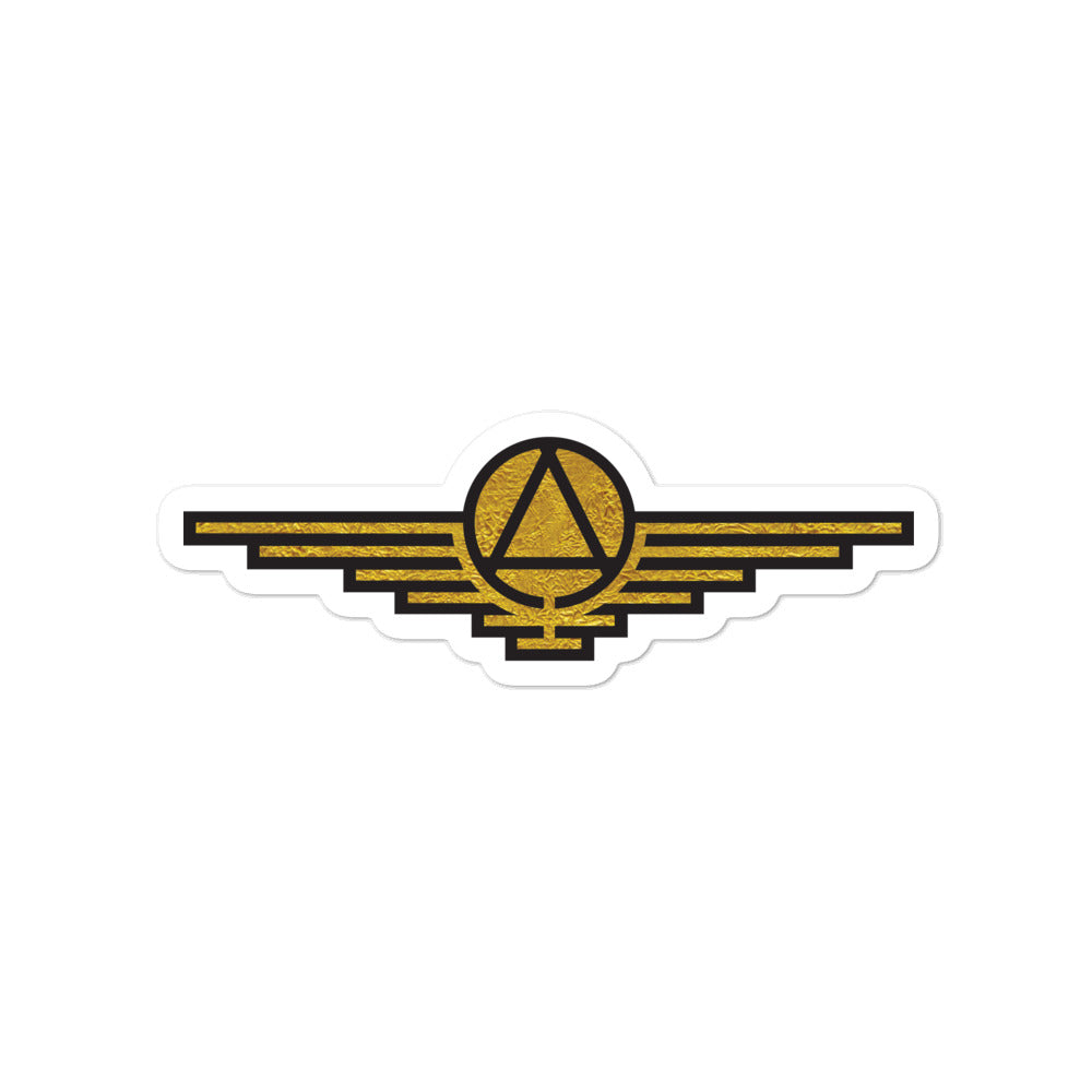 Gold sticker with black outlines depicting a triangle enclosed in a circle with wings extending on either side