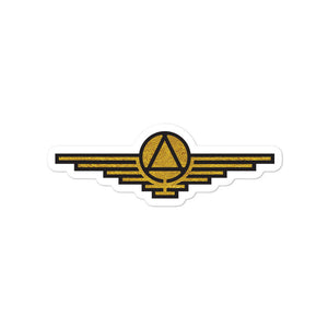 Gold sticker with black outlines depicting a triangle enclosed in a circle with wings extending on either side