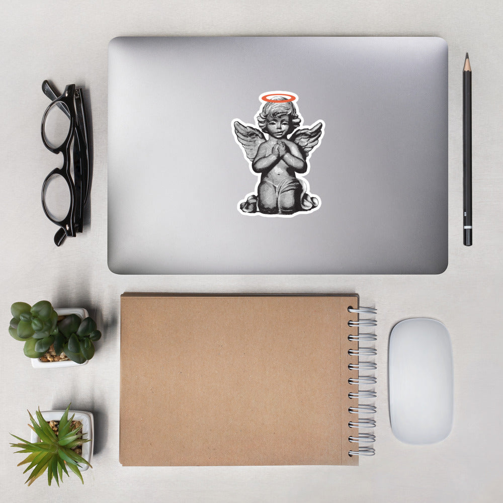 Sticker of a smirking praying angel statue with an orange halo