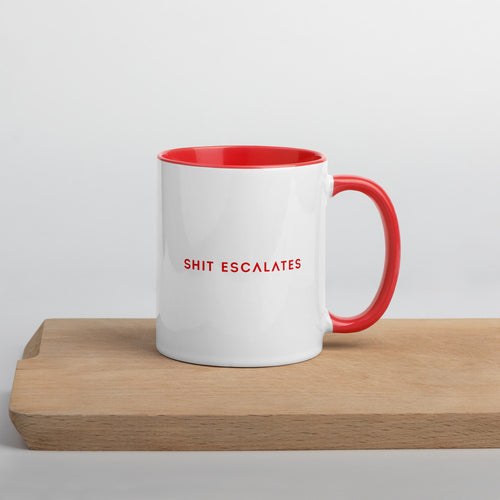 White ceramic mug with red handle and interior that says Shit Escalates in red 
